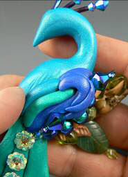 Clay peacock with glass beads